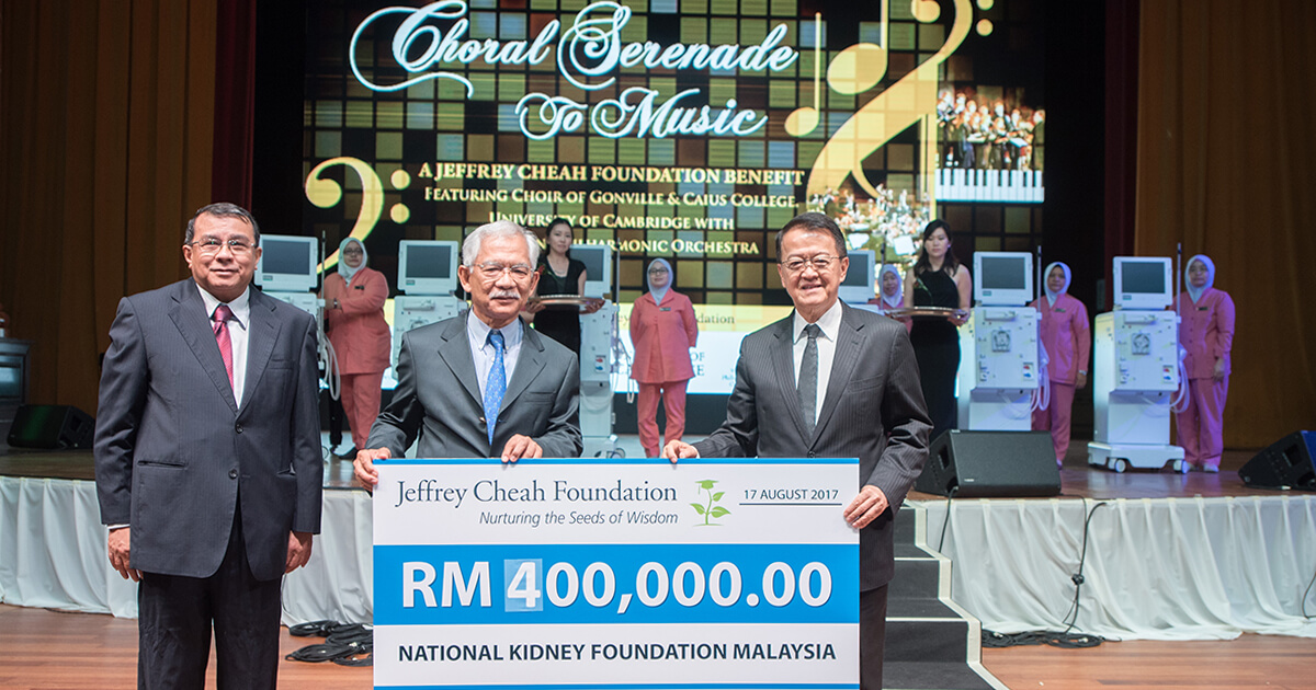 Tan Sri Sir Dr Jeffrey Cheah contributing a cheque of RM400,000 for NKF in front of dialysis machines before a stage.