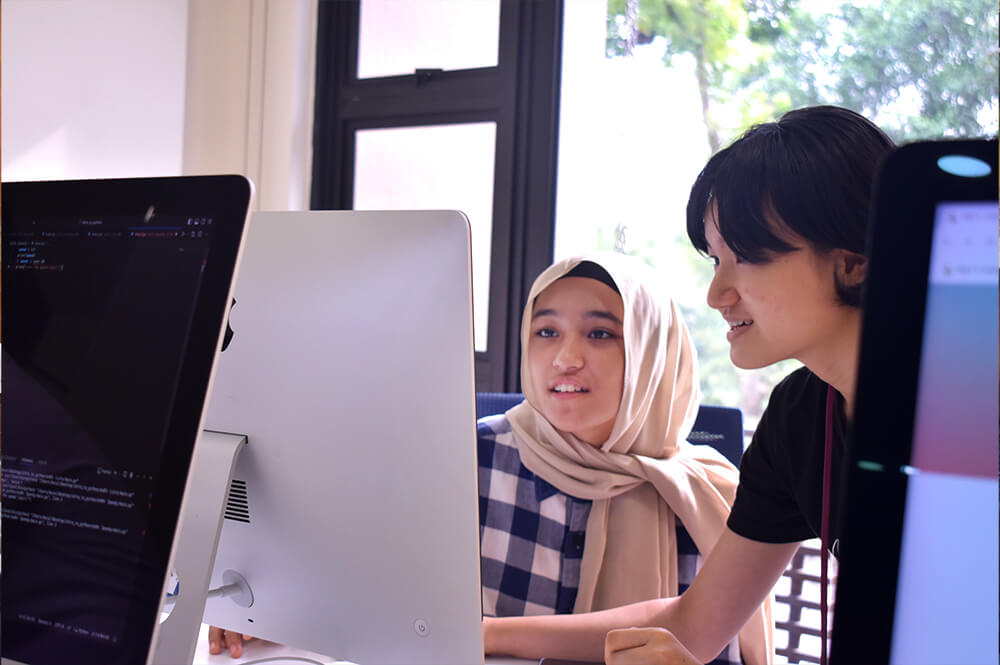 A mid-shot of a dedicated student volunteer from 42KL leading instructional sessions with carefully crafted lesson plans in the Code4TheFuture programme.