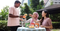 A mid-shot of three friends at Sunway XFarms enjoying GreenBliss Kale Tea.