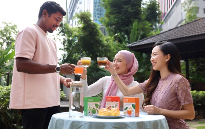 A mid-shot of three friends at Sunway XFarms enjoying GreenBliss Kale Tea.