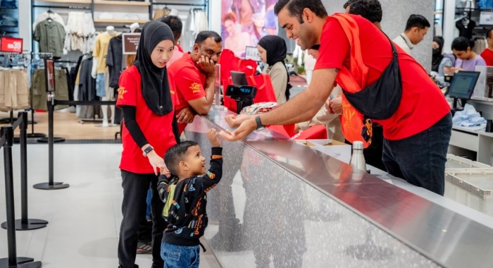 A mid-shot of a Sunway staff servicing a child at Sunway Carnival Mall