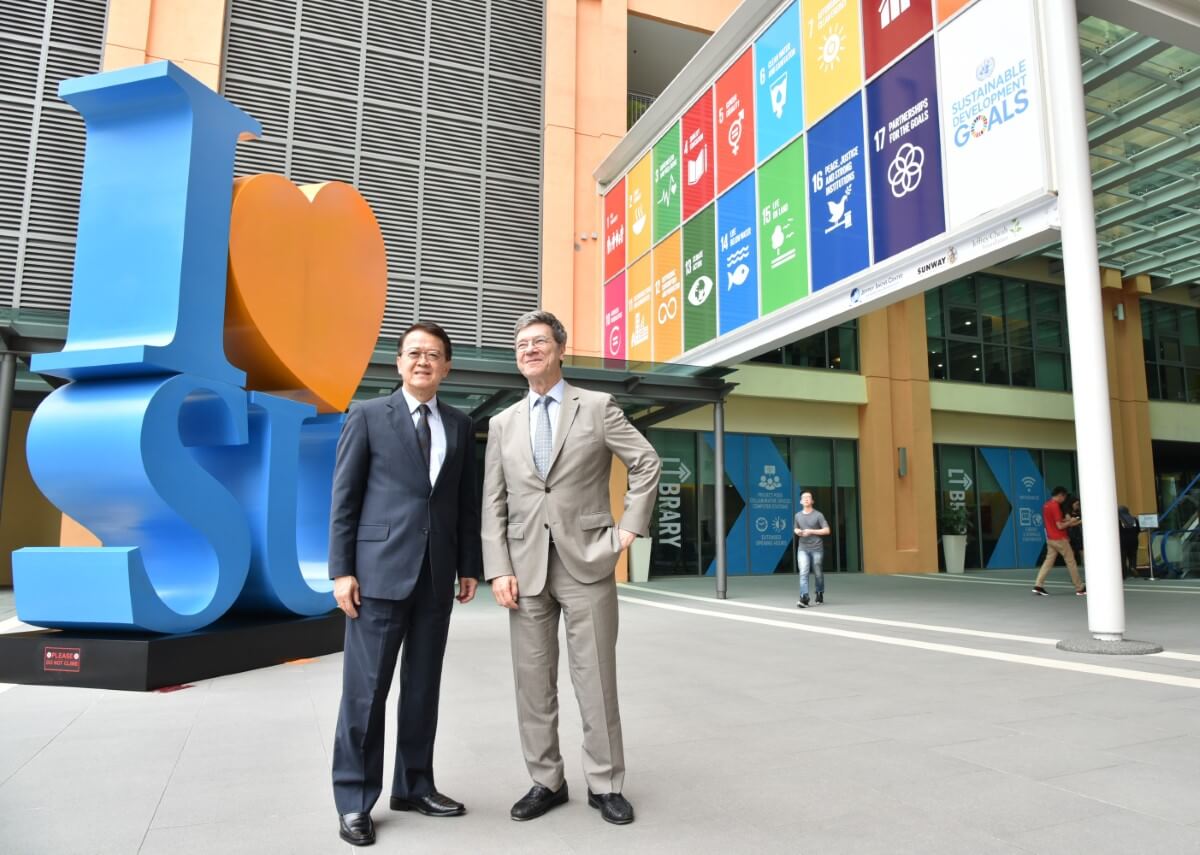 Tan Sri Sir Dr. Jeffrey Cheah with Prof. Jeffrey David Sachs at Sunway University. There are SDG signs in the background.