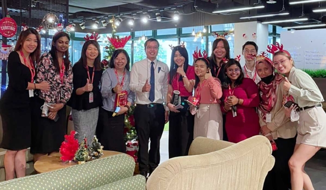 A group photo taken during a Christmas lunch.