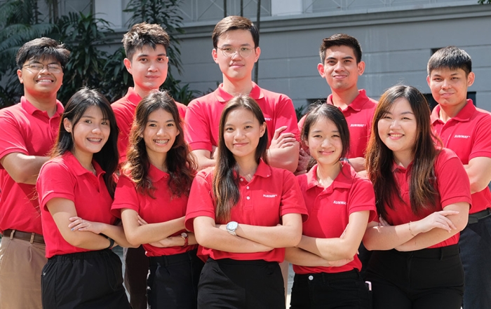 The Management Associates of Sunway taking a formal photo together in their Sunway collared red t-shirt.