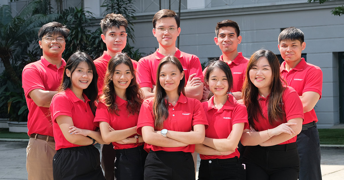 The Management Associates of Sunway taking a formal photo together in their Sunway collared red t-shirt.